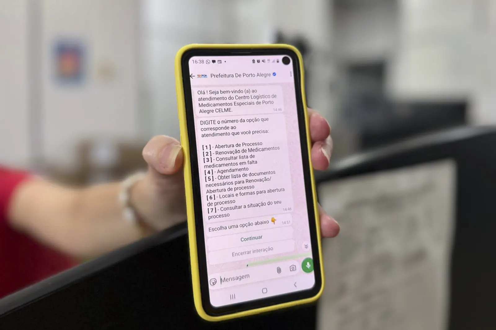 Celular mostrando um menu de atendimento automático no WhatsApp com opções numeradas
