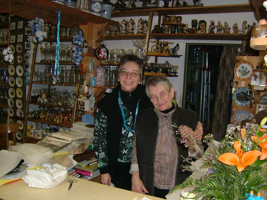 Duas comerciantes sorridentes atrás do balcão de uma loja de presentes, atendimento que ajuda a melhorar as vendas no comércio