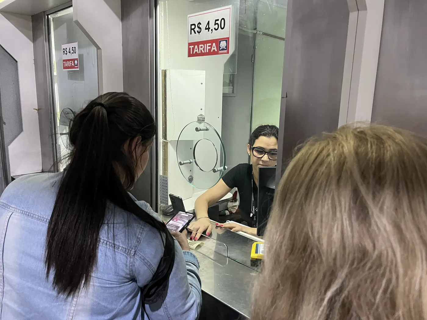 Cliente pagando com Pix pelo celular no guichê de atendimento, prática que o Pix parcelado deve ampliar